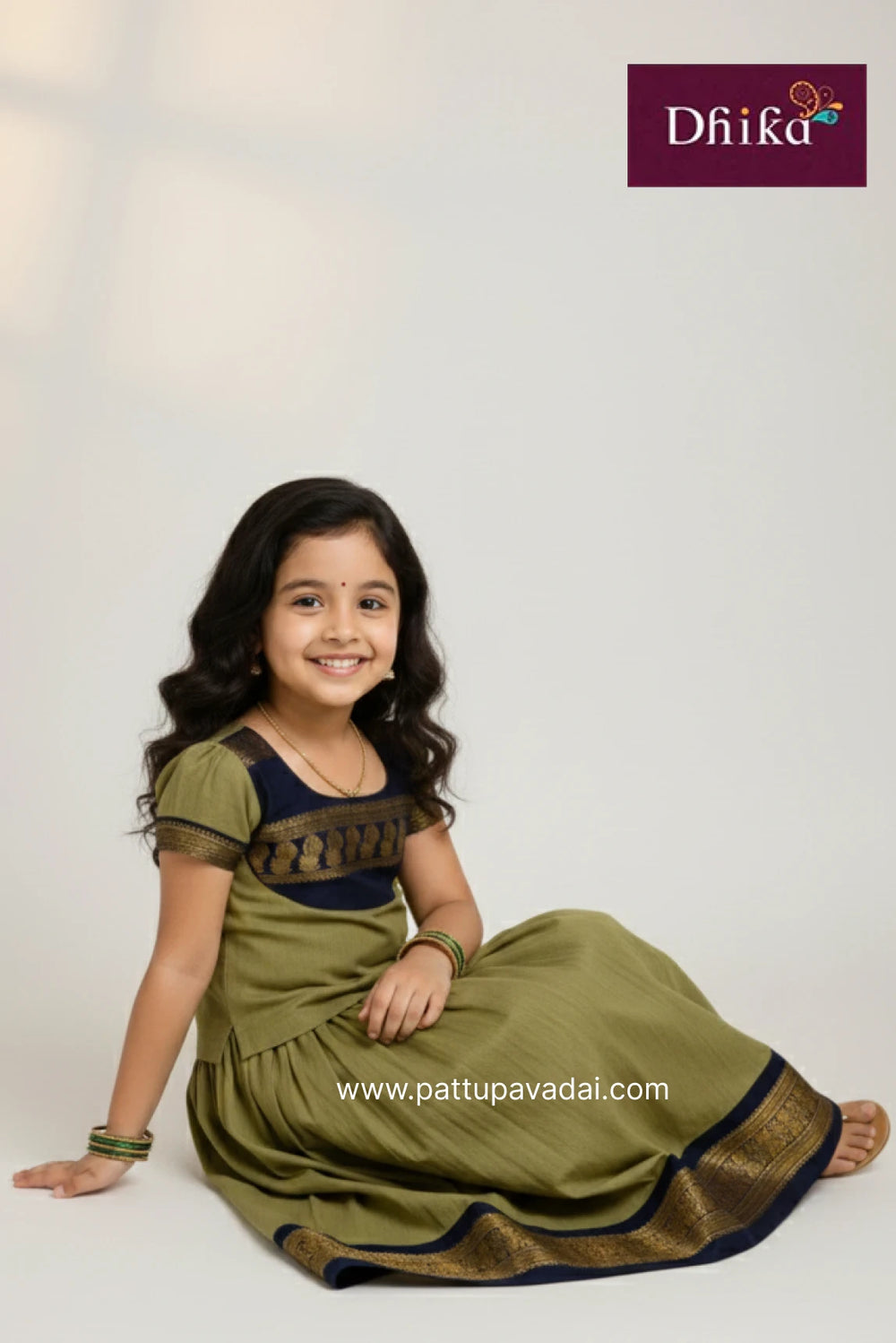 Young girl in a green traditional outfit with Dfiika branding on a white background