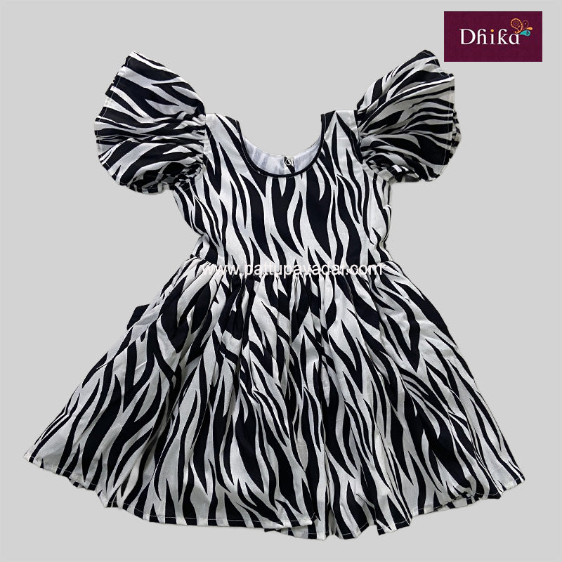 A black georgette frock with a zebra stripe pattern, featuring short puffed sleeves and a knee-length skirt.