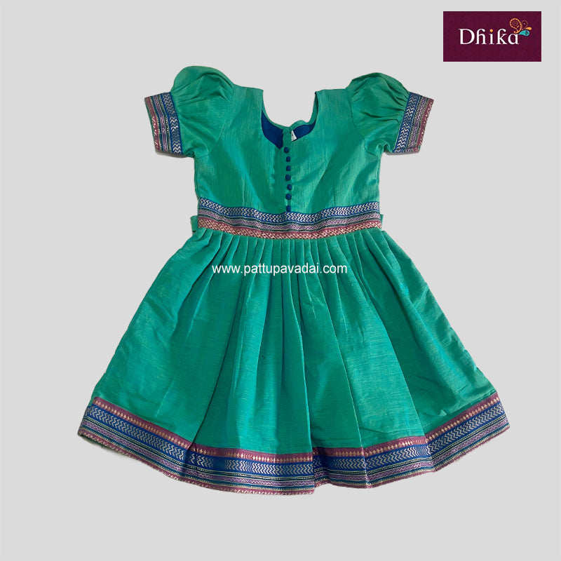 A sea green cotton frock with short sleeves, a round neckline, and a pleated skirt with a decorative border.