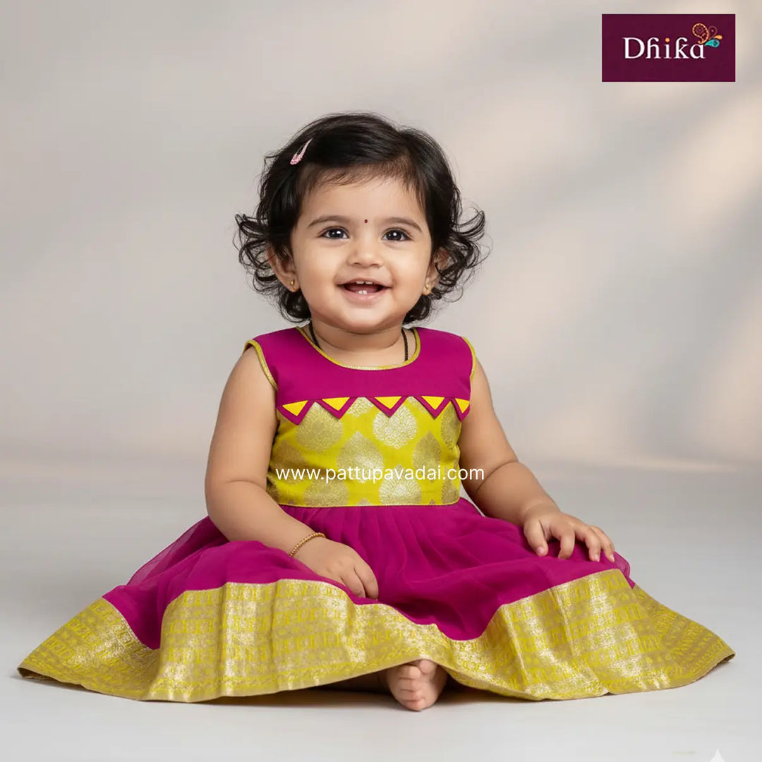 Child wearing a pink and yellow traditional outfit with 'Dhika' branding.
