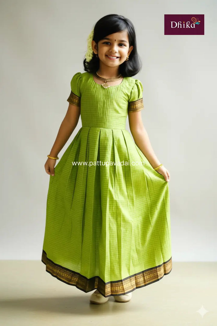 Young girl wearing a green traditional outfit with a plain background
