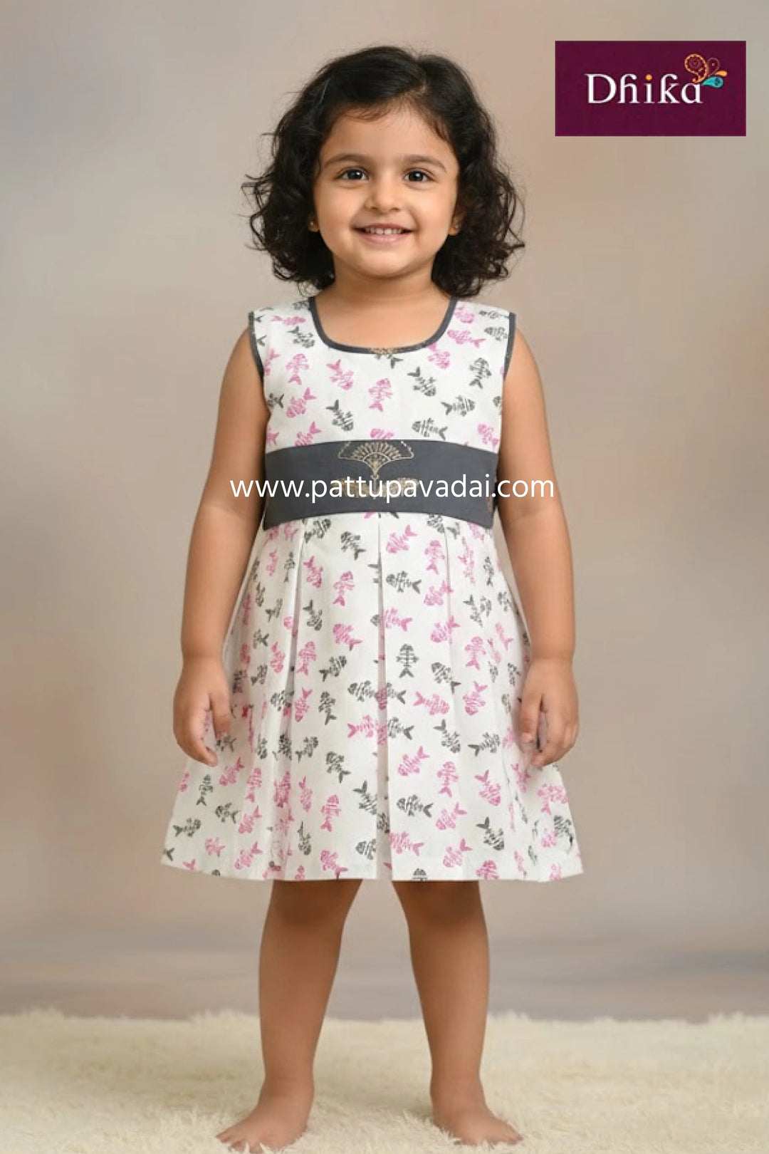 Young girl wearing a floral dress with a plain background, featuring the Dhika brand.