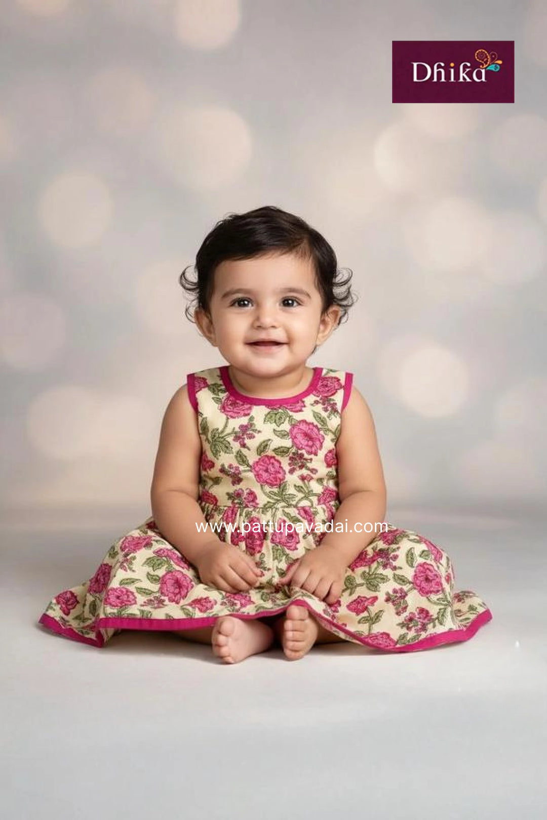 Baby wearing a floral dress with a soft focus background and Dhika brand logo.