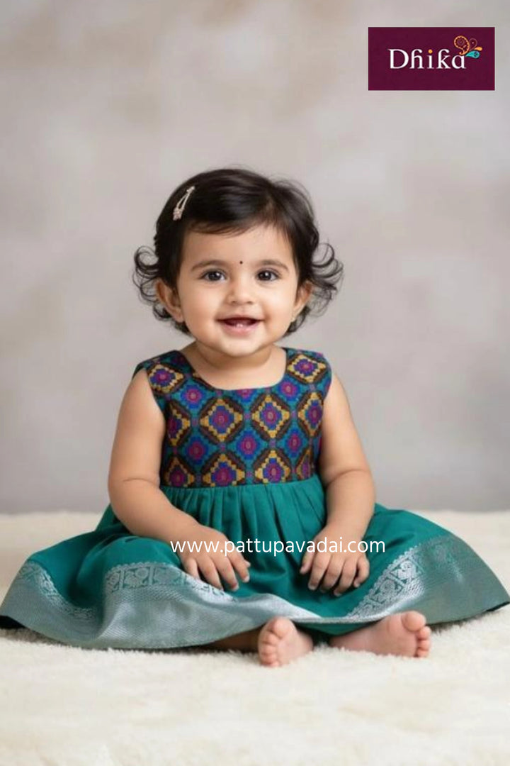Baby wearing a traditional outfit with a visible brand logo on a plain background