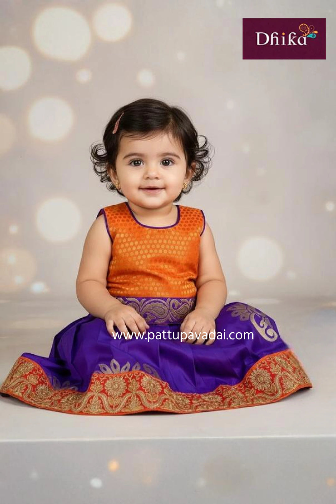 Child wearing an orange and purple traditional outfit with a blurred light background