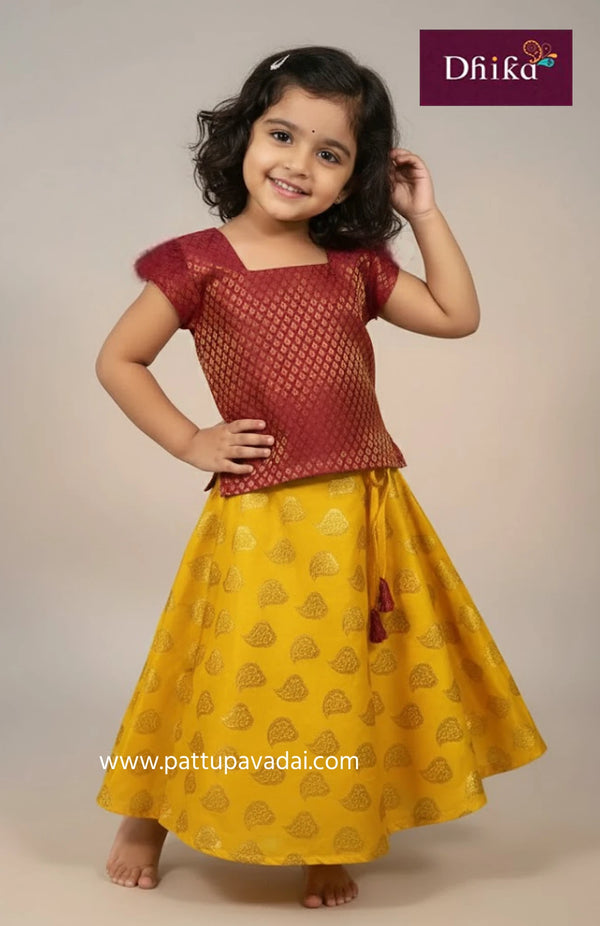 Young girl wearing a red top and yellow skirt with 'Dhika' branding.