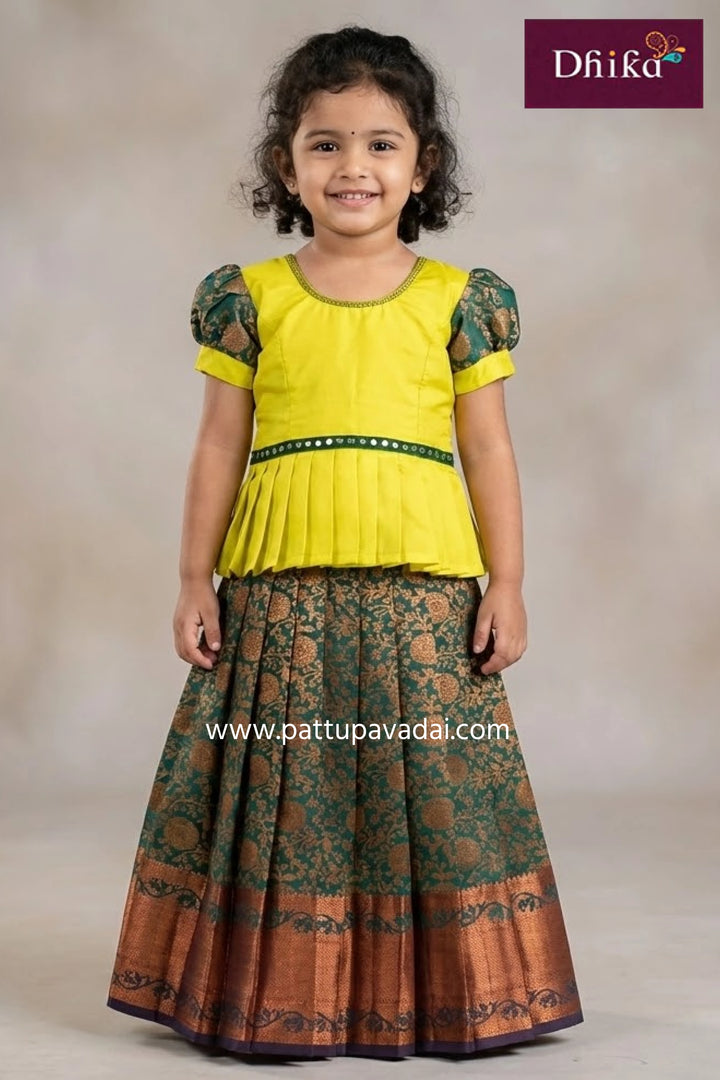Young girl wearing a green and purple traditional outfit with Dhika logo.