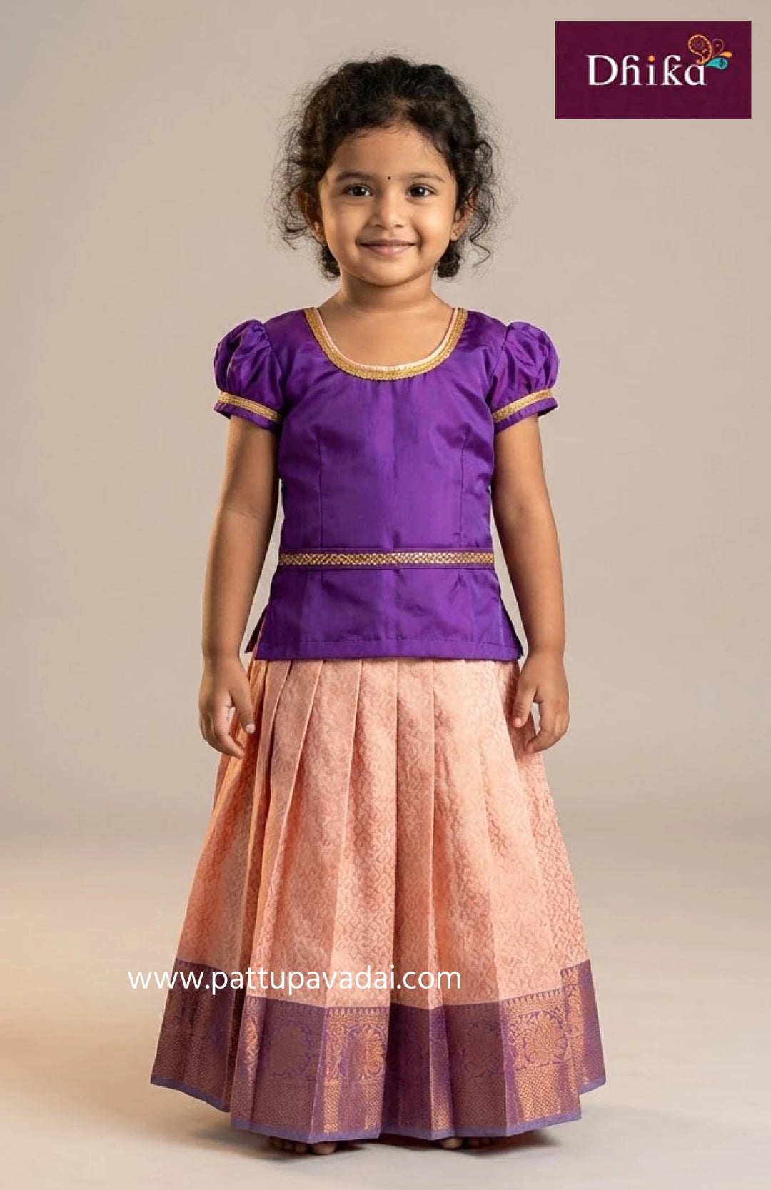 Young girl wearing a purple top and pink skirt with 'Dhika' branding.