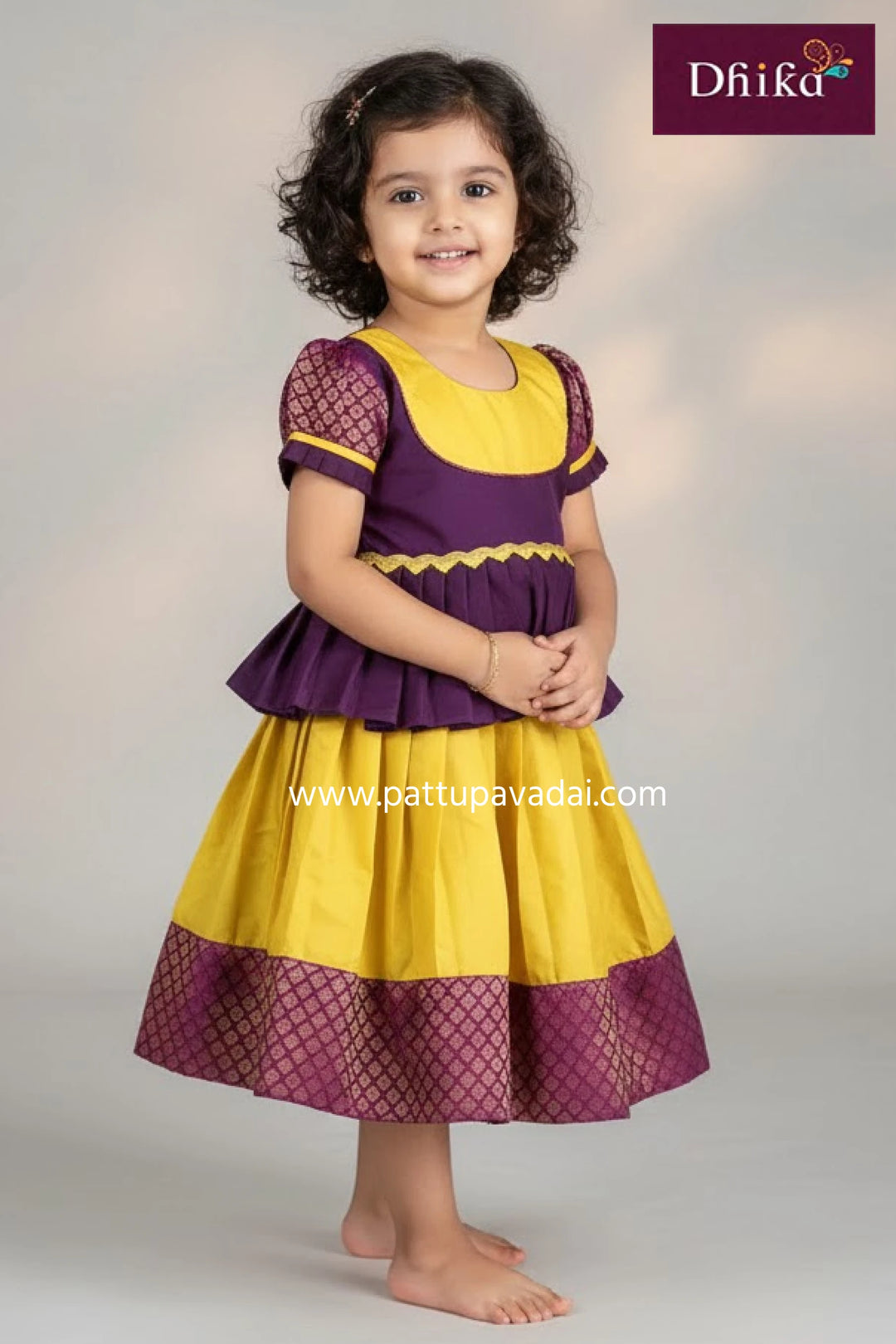 Young girl wearing a yellow and purple dress with 'Dhika' branding.