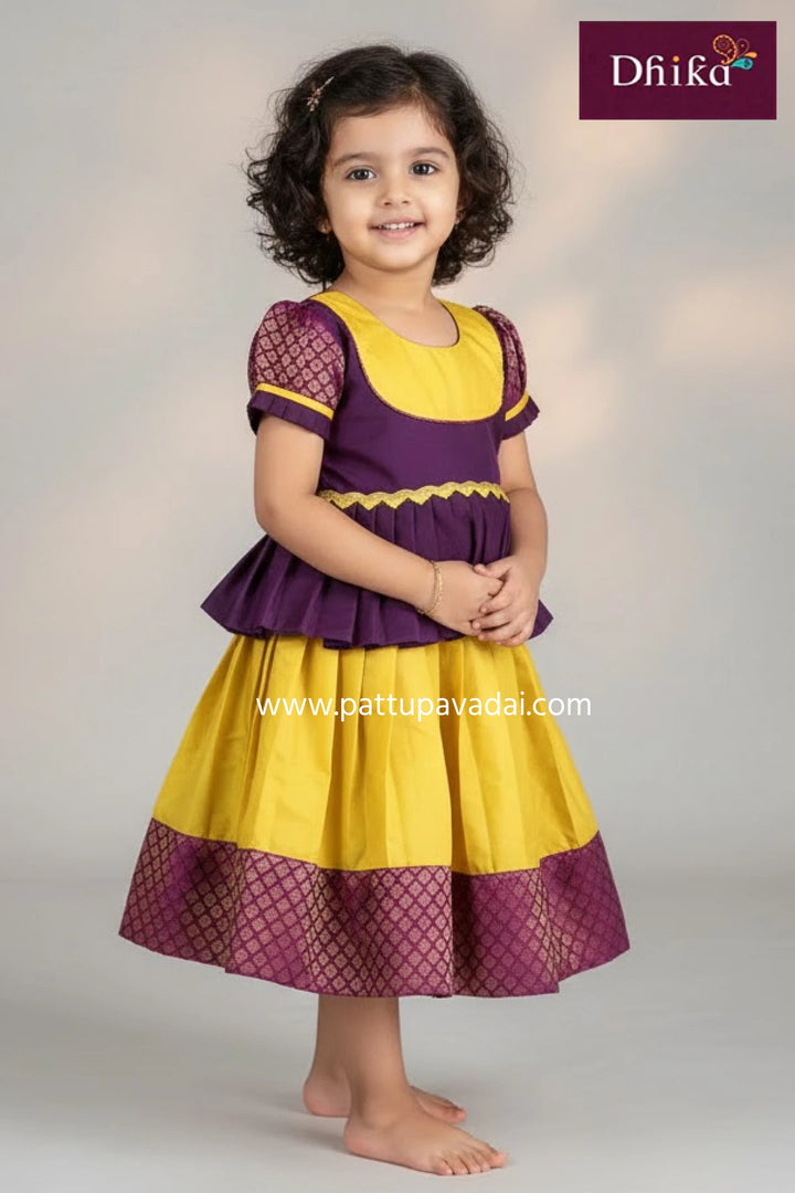 Young girl wearing a yellow and purple dress with 'Dhika' branding.