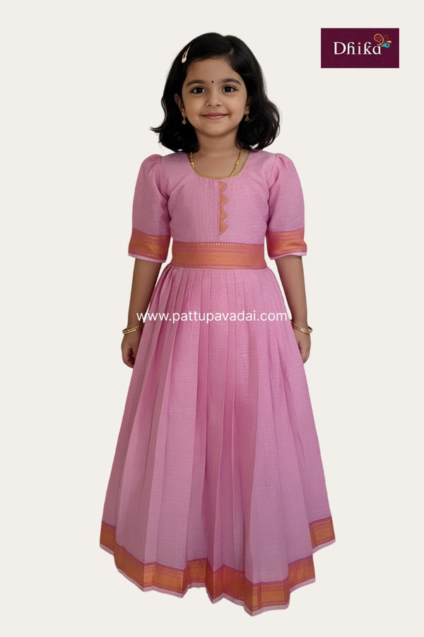 Young girl wearing a pink traditional outfit with orange accents on a white background, featuring the Drika brand.