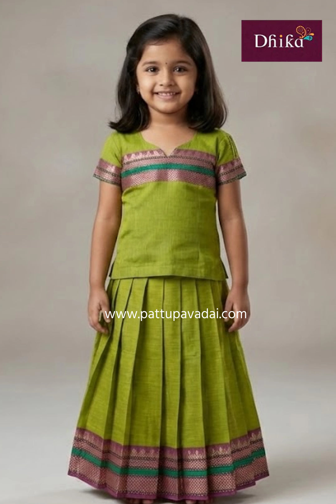 Young girl wearing a green traditional outfit with a plain background