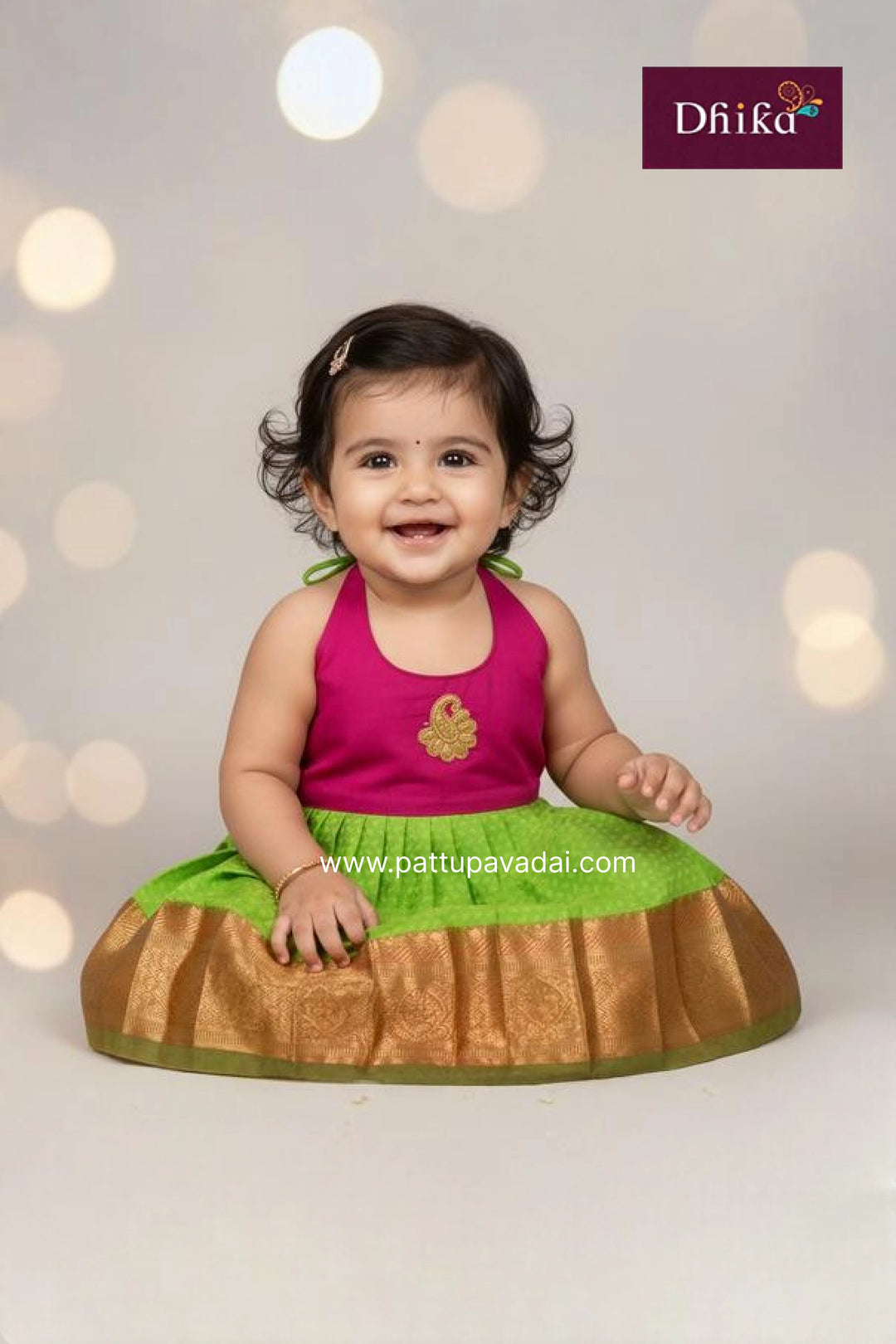 Baby wearing a pink top and green skirt with a blurred light background