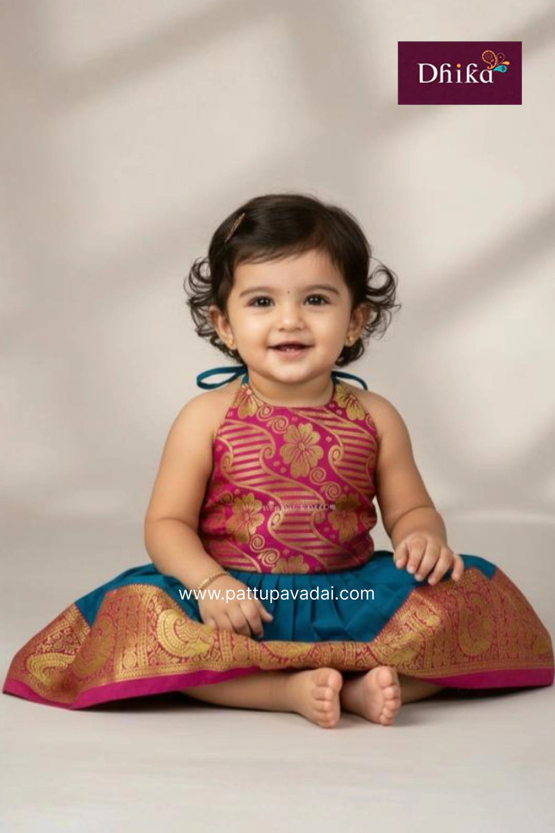 Child wearing a traditional outfit with a visible brand logo on a plain background
