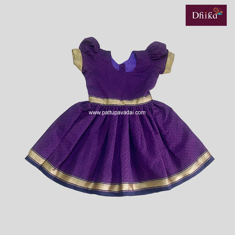 A purple cotton frock with short puffed sleeves, a round neckline, and a golden border at the hem.