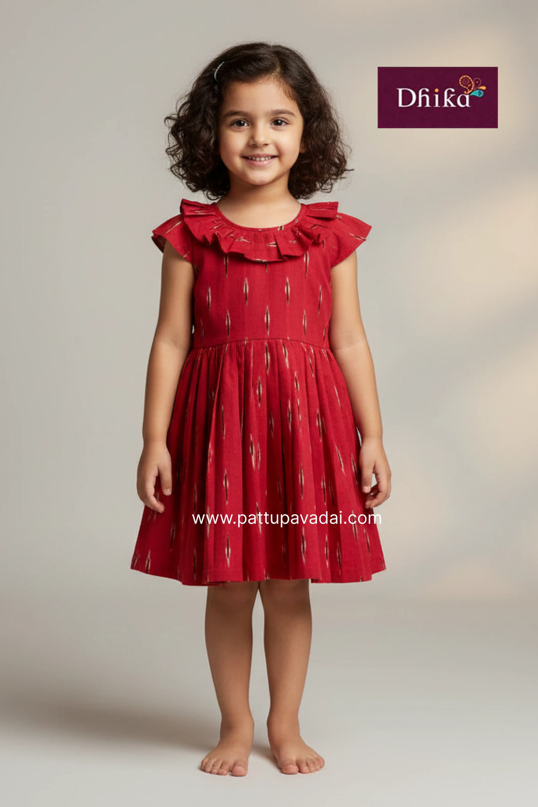 Young girl wearing a red dress with ruffled sleeves on a plain background, with 'Dhika' branding visible.