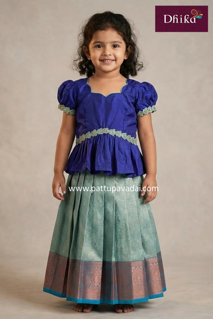 Young girl wearing a blue top and green skirt with a beige background