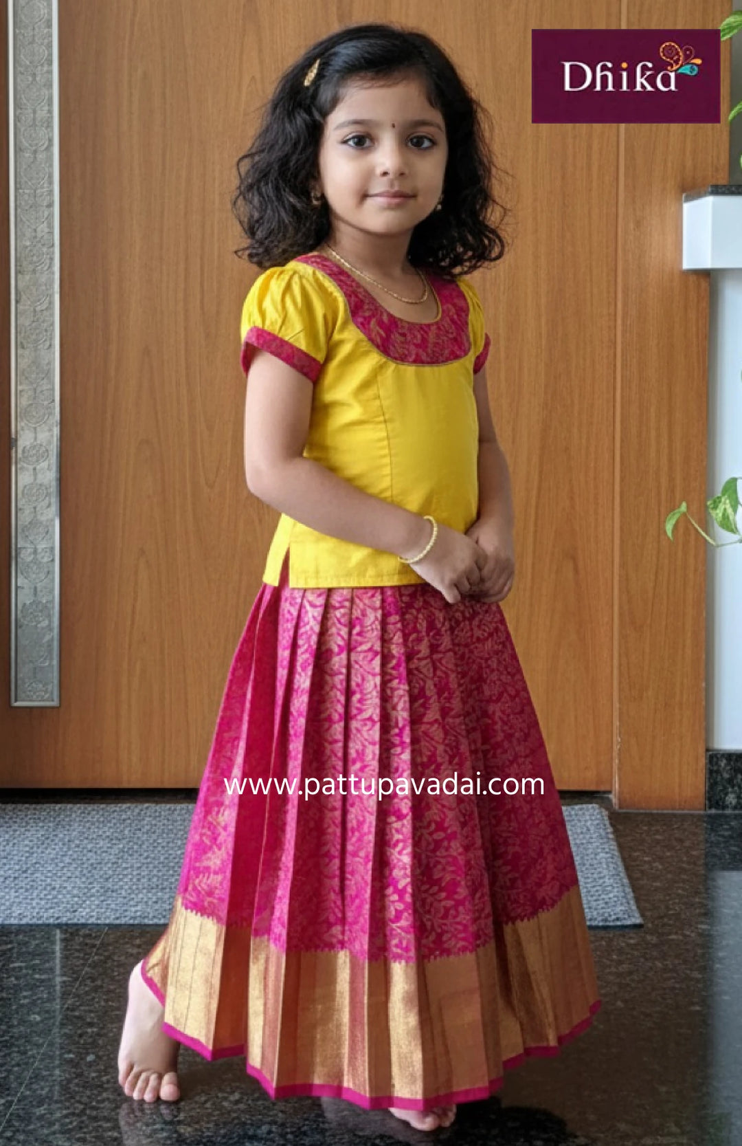 pink and yellow semi kanchi pattu pavadai traditional dress for girls