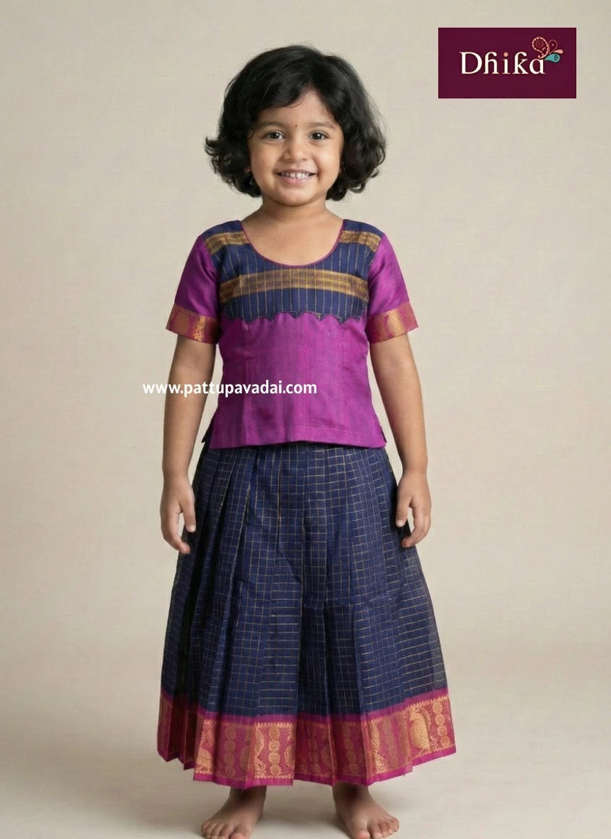 Child wearing a purple and navy traditional outfit with 'Dhika' branding.